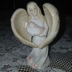 Vintage angel holding baby